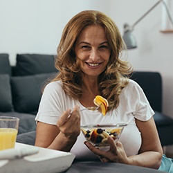 Lady eats fruit